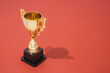 © Brkati Krokodil/Stocksy - Golden Trophy On Red Background With Copy Space