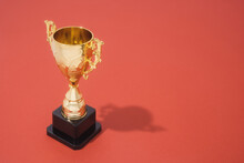 Golden Trophy On Red Background With Copy Space