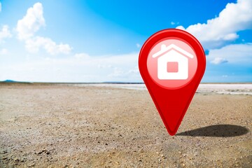 Canvas Print - House symbol with location pin icon on empty dry cracked swamp reclamation soil, investment concept,