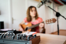Woman Playing And Recording Music At Home Studio