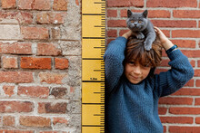 Kid And Cat Against By Measure Tape