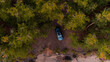 © Yakov Knyazev/Stocksy - Overhead view Of a brand new blue SUV in the wild