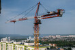 © Yakov Knyazev/Stocksy - giant building crane above the city line on a sunny day