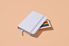 Rainbow Flag Peeking Out From A Notebook