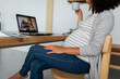 © Valentina Barreto/Stocksy - Pregnant woman doing a video call at home