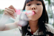© Pansfun Images/Stocksy - kid playing bubble blowing game