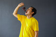 © Gatot - Asian man eating fresh purple grapes for healthy life style concept