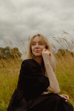 Young Blonde Woman In Grassy Area
