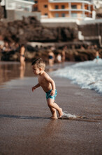 Running Toddler At Beach.