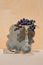 Inverted Wine Glass With Grapes And Carved Stone