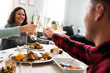 © Daniel - Happy family toasting with champagne on Christmas day. Selective focus on hands and glasses.