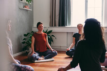 Group Of Women Meditating In A Yoga Class