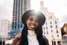 Happy Black Woman In Leather Coat And Hat