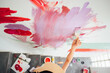 © MaaHoo Studio/Stocksy - asian girl painting on the wall
