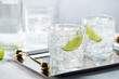 © Jeff Wasserman/Stocksy - Glasses of Gin and Tonic with Lime Garnish