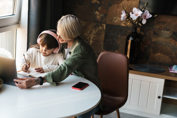 Canvas Print - Mother helping her daughter with her homework