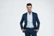 © Drobot Dean - Smiling european businessman with hands in pockets