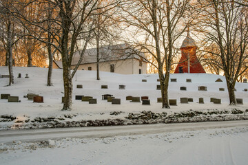 Wall Mural - Cemetery with a belfry on a hill in winter