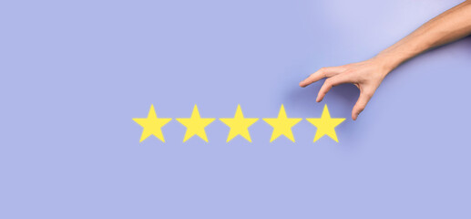 Man holds smart phone in hands and gives positive rating, icon five star symbol to increase rating of company concept on blue background.Customer service experience and business satisfaction survey.