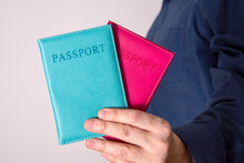 The Hand Holds Two Passports With An Unknown Citizen.