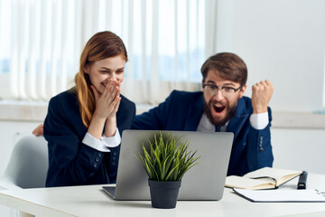 Poster - business man and woman teamwork in the office with laptop professionals