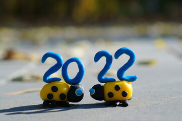 Canvas Print - The number 2022 and two ladybugs made of plasticine. Calendar date. A festive event. New Year's Eve.