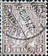 Switzerland - Circa 1882  : a postage stamp from the Switzerland showing the representation of the seated Helvetia the symbol of the Confederation