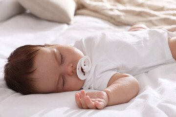 Sticker - Cute little baby with pacifier sleeping on bed