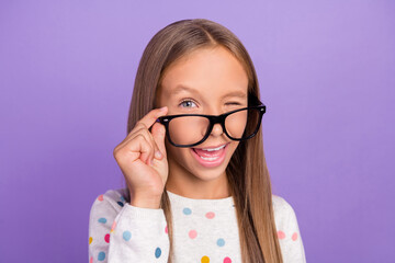photo of funny geek small lady wink eye wear spectacles dotted pajama isolated purple color backgrou