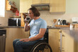 © Wavebreak Media - Caucasian disabled man sitting on wheelchair drinking coffee in the kitchen at home