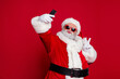 © deagreez - Photo of funky handsome santa claus wear red costume hat eyewear showing v-sign tacking selfie lips pouted isolated red color background