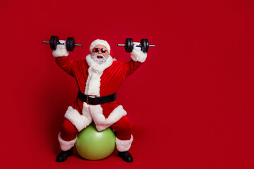 Poster - Full length body size view of attractive cheerful Santa working out aerobics isolated over bright red color background