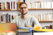 © BalanceFormCreative - Portrait of male student studying in campus library .