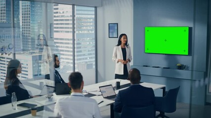 Poster - Diverse Office Conference Room Meeting: Successful Asian Businesswoman Talks, Uses Green Screen Chroma Key Wall TV for Presenting Product to Group of Investors. e-Commerce Strategy. Wide Shot