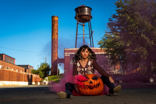 Model Poses With A Jack O Lantern With Smoke For The Halloween holiday in the United States