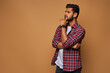 © Тарас Нагирняк - Young handsome indian man in casual close with crossed arms on pastel background with copy space
