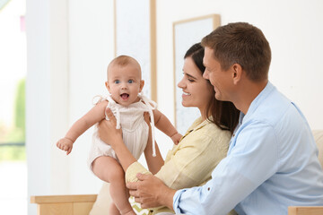 Canvas Print - Portrait of happy family with their cute baby at home