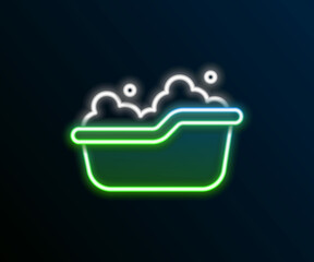 Sticker - Glowing neon line Baby bathtub with foam bubbles inside icon isolated on black background. Colorful outline concept. Vector