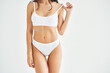 © GVS - Perfect sporty body in white underwear of young woman