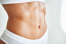 Close Up Belly Of A Beautiful Sporty Girl In Drop Of Sweat Or Water On Skin