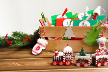Christmas Advent Calendar On The Table, In A Wooden Box. Multicolored Envelopes Made By Hand