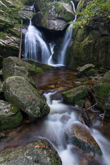 Wall Mural - Autumn fall mountain waterfall stream in the rocks with colorful fallen dry leaves, landscape, natural seasonal background