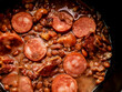 detail of feijoada with feijão manteiga with pepperoni bacon and dried meat 