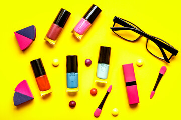 make up set on yellow background top view