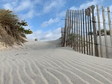 Sand And Wooden Fence At A Beach
