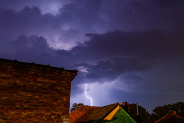 Wall Mural - building under the lightning sky background