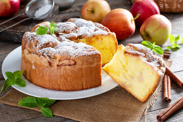 Sponge cake or chiffon cake with apples, so soft and delicious with ingredients: eggs, flour, apples on table. Homemade bakery concept for background and wallpaper.