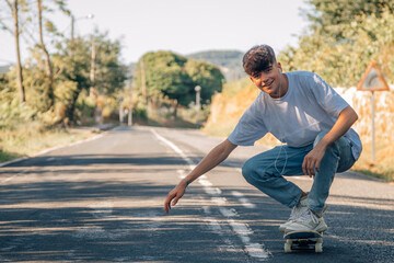 Poster - teenage boy with skateboard on the road