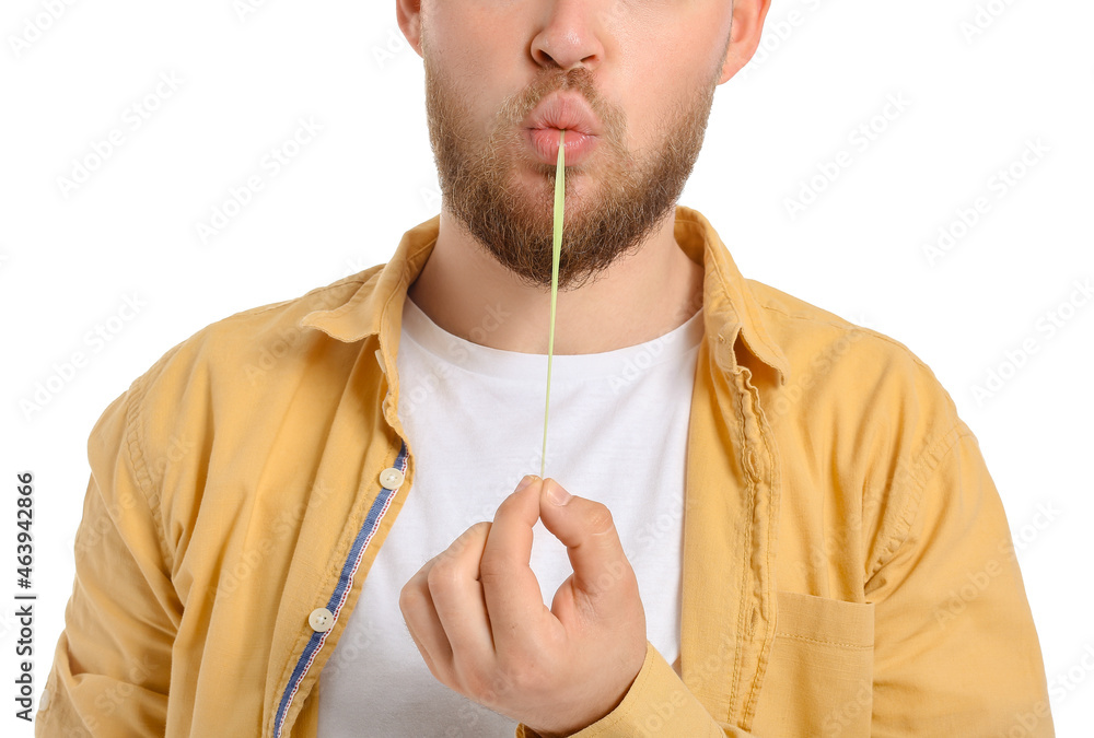 Young man with chewing gum on white background