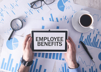 Man holding tablet computer with a Employee Benefits text.